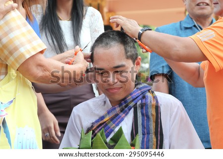 Phuket Thailand ,June 26 : Shaved ordained Buddhist ceremony in Thailand. Thai man gets his head shaved   JUNE 26 , 2015 : in Wat  Kathu Phuket  Thailand