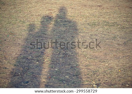 Parents and children ,shadow on The grass in the park,vintage tone