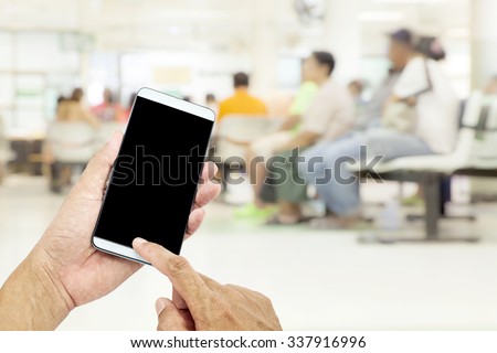 Man Asian hand hold and touch screen smart phone, on Blurred background Patient waiting for see doctor background