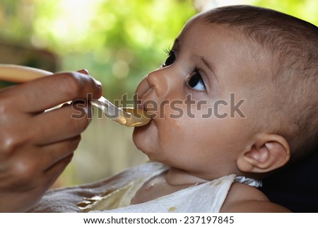 adorable baby have a lunch outdoor and taste the good food