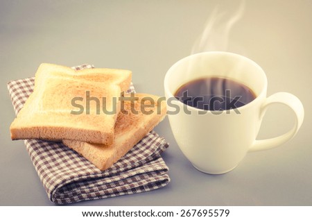 Coffee cup and sliced bread on napkin