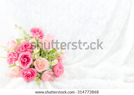 Pastel Coloured Artificial Pink Rose Wedding Bridal Bouquet on white fur background with soft vintage tone