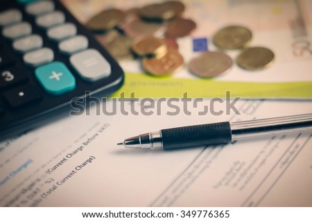 Close up of Pen and statement paper with euro money and calculator - Vintage and vignette tone