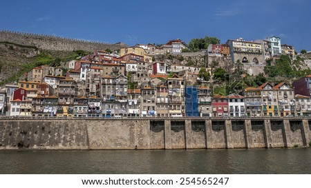 Portugal , Porto, the embankment of  Duora river , residential quarters of the old town , on the balconies drying clothes . The fortress wall .