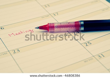 Pen for writing and a calendar  for future business decisions and meetings