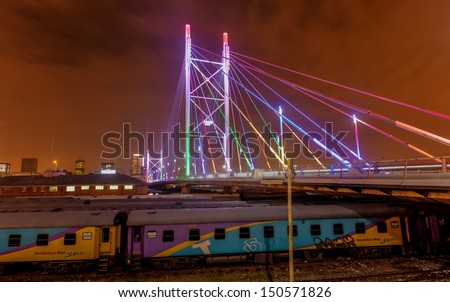 Nelson Mandela Bridge at night. The 284 meter long Nelson Mandela Bridge connecting Newtown, which was opened by Nelson Mandela himself. Seen over the 40 railway lines it helps traverse.