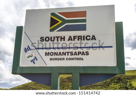Monantsapas Border Control Sign between South Africa and Lesotho with the mountains of Lesotho in the background.