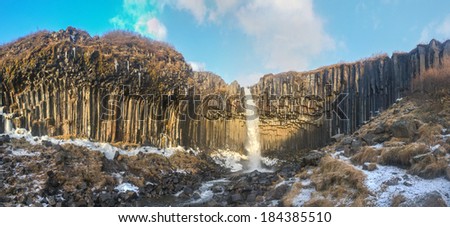 Panorama of Svartifoss Waterfall in Early Winter. Svartifoss (Black Fall) is a waterfall in Skaftafell in Vatnajokull National Park in Iceland, and is one of the most popular sights in the park.