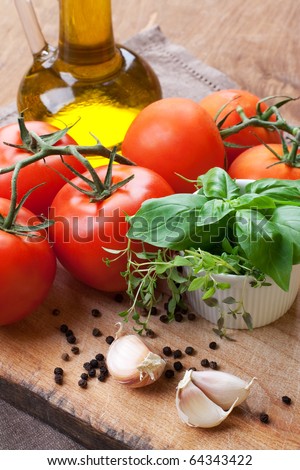 Fresh tomatoes, basil, thyme and olive- still life