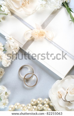 Wedding invitation, romantic background with wedding bands and pearls- vintage style.