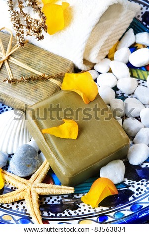 Mediterranean bath: decorative still life with olive and herbal soap bars.