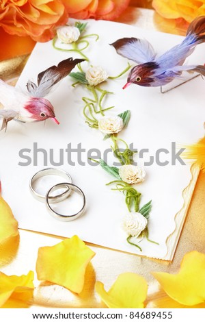 Wedding invitation, decorative still life with birds, roses, and feathers.