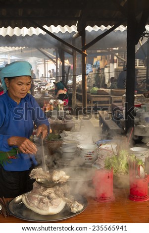 Bac Ha, Vietnam - 16 June 2013 : A woman is cooking boiled meat at Bac Ha morning market, North Vietnam.
