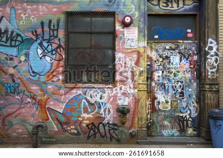 Brooklyn, New York, United States - 17 August 2015 : Tagged door and wall with graffiti in Williamsburg Brooklyn