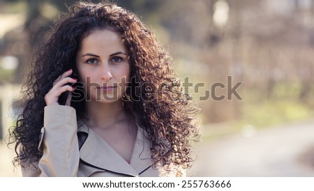 Phone call / Beautiful girl talk with someone.Close up portrait. To the image is some light and color effects  and fine film noise added