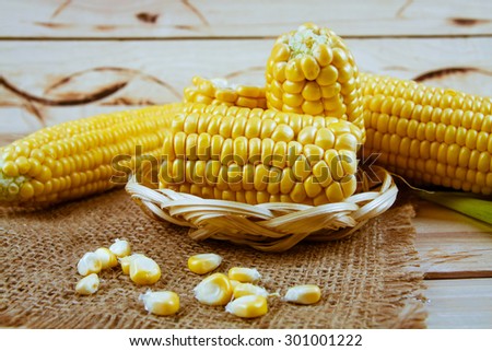 Freshly harvested corn on wooden background, corn oil