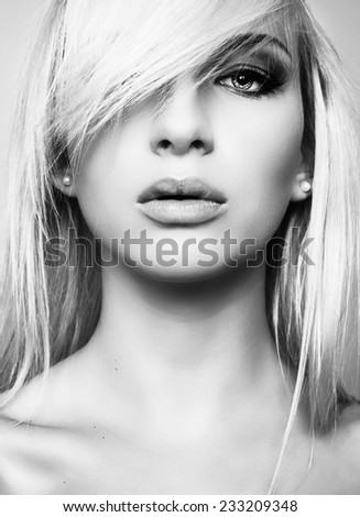 beautiful young woman with blond hair and perfect skin in black and white