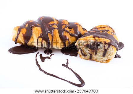 Two croissants with melted chocolate on them isolated on white