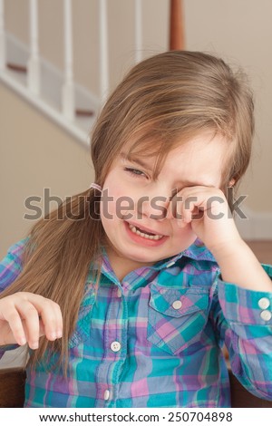 sad adorable little girl crying at home