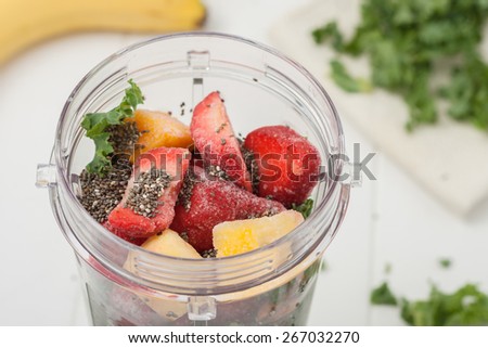 homemade healthy smoothie ingredients: frozen fruit, kale and chia seeds