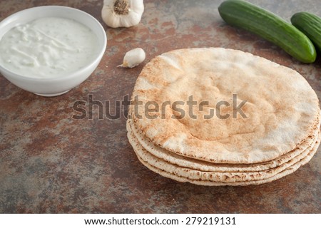 stack of fresh pita bread on textured stone background