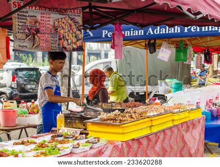 Kuala Lumpur,Malaysia - July 13, 2014: The hawkers preparing the foods in Ramadan Bazaar.It is established for muslim to break fast during the holy month of Ramadan.
