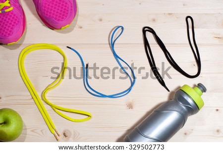 Running equipment on the floor. Shoelaces shaped word RUN