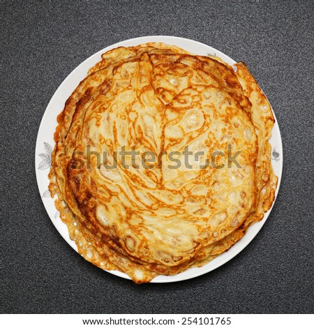 A stack of pancakes on a plate. Russian traditional food for the holidays (maslenitsa). Top view.