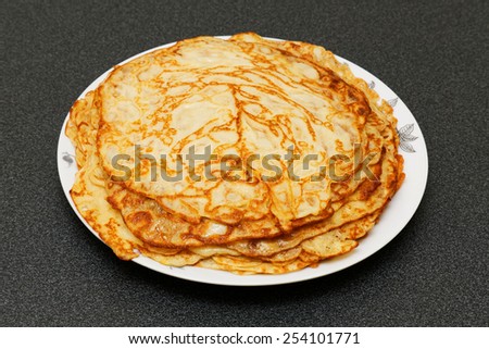 A stack of pancakes on a plate. Russian traditional food for the holidays (maslenitsa).