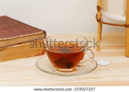 Cup of tea and books on woody table