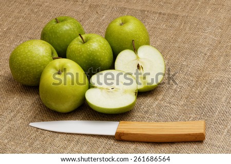 Six small green apple and ceramic knife  on the bagging