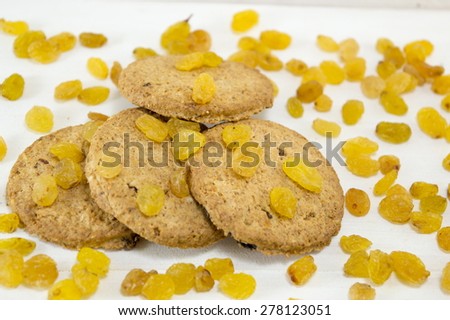 Integral cookies and yellow raisins on white