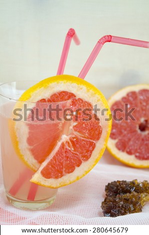 Fresh grapefruit juice in a glass decorated with red grapefruit slice