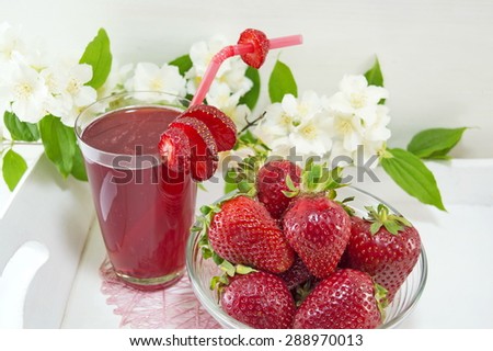 Strawberry juice and fresh strawberries served on the flowers decorated plate