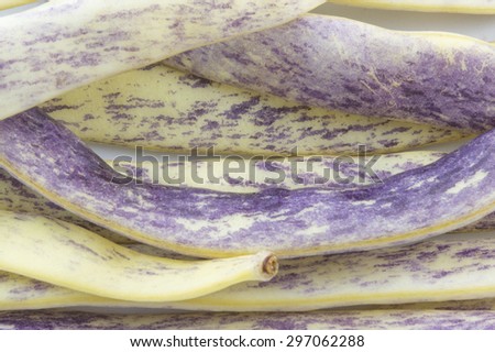 Purple beans closeup forming background
