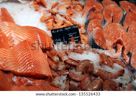 Salmon filets and shrimps for sale at fish market