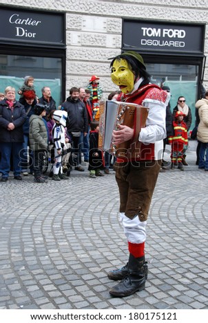 LJUBLJANA, SLOVENIA - MARCH 1, 2014: Traditional Slovene wooden facial mask and costume  at Dragon Carnival parade. The meaning is to  banish away the winter and announce spring.