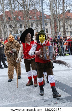 LJUBLJANA, SLOVENIA - MARCH 1, 2014: Traditional Slovene wooden facial masks and costumes at Dragon Carnival parade. The meaning is to  banish away the winter and announce the spring. Ljubljana,