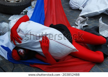 LJUBLJANA, SLOVENIA - JULY 2, 2014: Teatr Brovi from Ukraine with performance  Colored Men at  street theater Ana Desetnica. Story reflects the current situation in Ukraine. Red man in Russian flag.