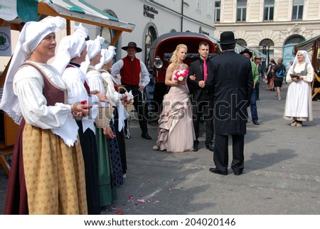 LJUBLJANA, SLOVENIA - JUNE 14, 2014: Traditional wedding from Poljane valley, Gorenjska region, with folk costumes and folk music, in open air at market place. Such wedding are still popular nowadays.