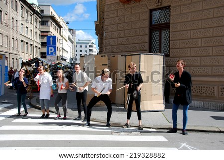 LJUBLJANA, SLOVENIA - SEP. 22, 2014: Actors of Street Theater Ana Monro & Sugla take off masks after play Romeo and Juliet at Street Festival Our Streets, Our Decision on European Mobility Week 2014.
