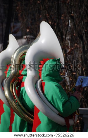 LJUBLJANA, SLOVENIA - FEBRUARY 15: Carnival parade on Shrove Saturday. Green dragons brass band masks with trumpets.  Green dragon is a symbol of Ljubljana. Ljubljana Slovenia February 15, 2012.