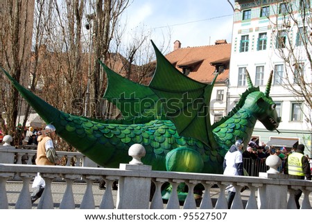 LJUBLJANA, SLOVENIA - FEBRUARY 15: Carnival on Shrove Saturday. Symbol of the city, big green dragon, made by pupils, on parade through the streets.   Ljubljana Slovenia February 15, 2012.