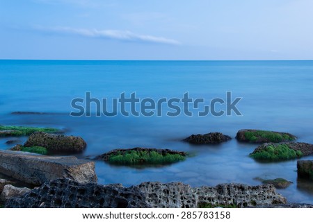 Sea waves and stones, long exposure used. Focus on the stones, evening time shoot. Great nature background. Relaxing and romantic seascape.