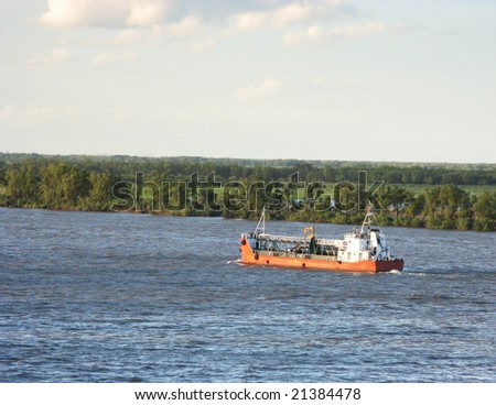 A medium ship going against the river tide, with and island in the background. Parana river, Rosario city, Argentina