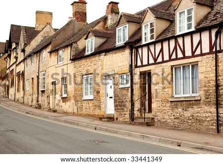 A row of stone cottages in a town in the Cotswolds, England
