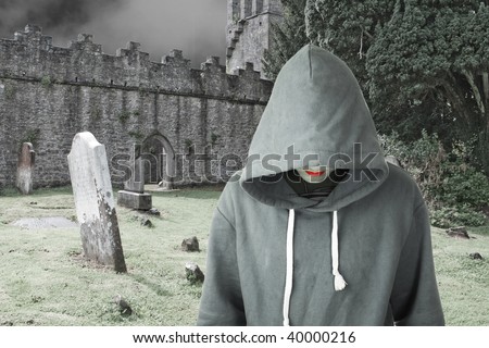 A hooded man in a graveyard