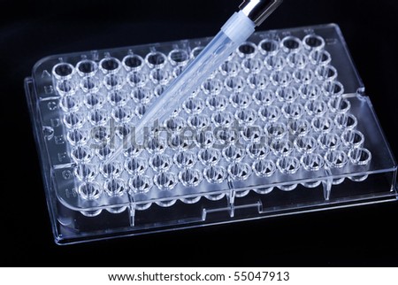 A pipette tip and a microtitre tray