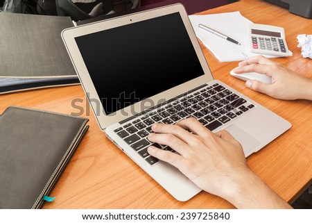 Workplace, book and laptop  on wooden table