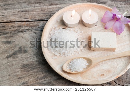 spa sea salt on wood plate with orchid ,wood background